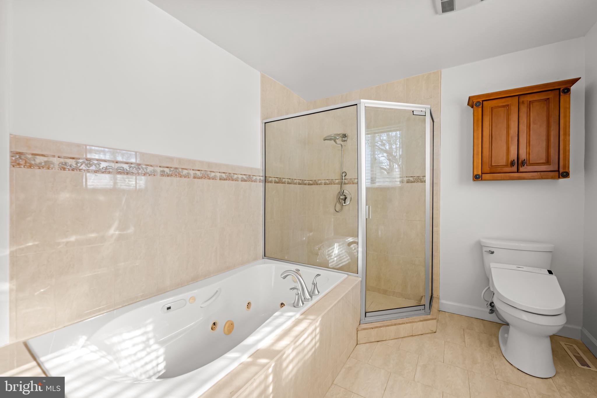 3407 Birch Hollow Road Baltimore, MD 21208 - Photo 33 of 47 a bathroom with a tub a toilet and a shower