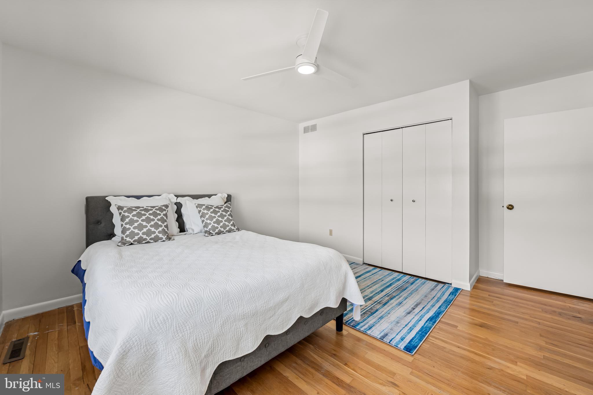 3407 Birch Hollow Road Baltimore, MD 21208 - Photo 35 of 47 a spacious bedroom with a bed and wooden floor