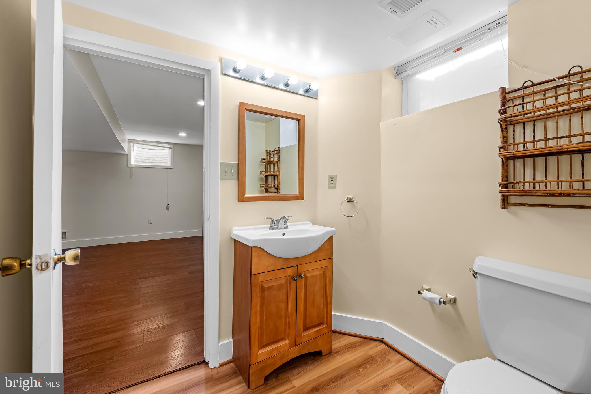 3407 Birch Hollow Road Baltimore, MD 21208 - Photo 43 of 47 a bathroom with a sink a toilet and mirror
