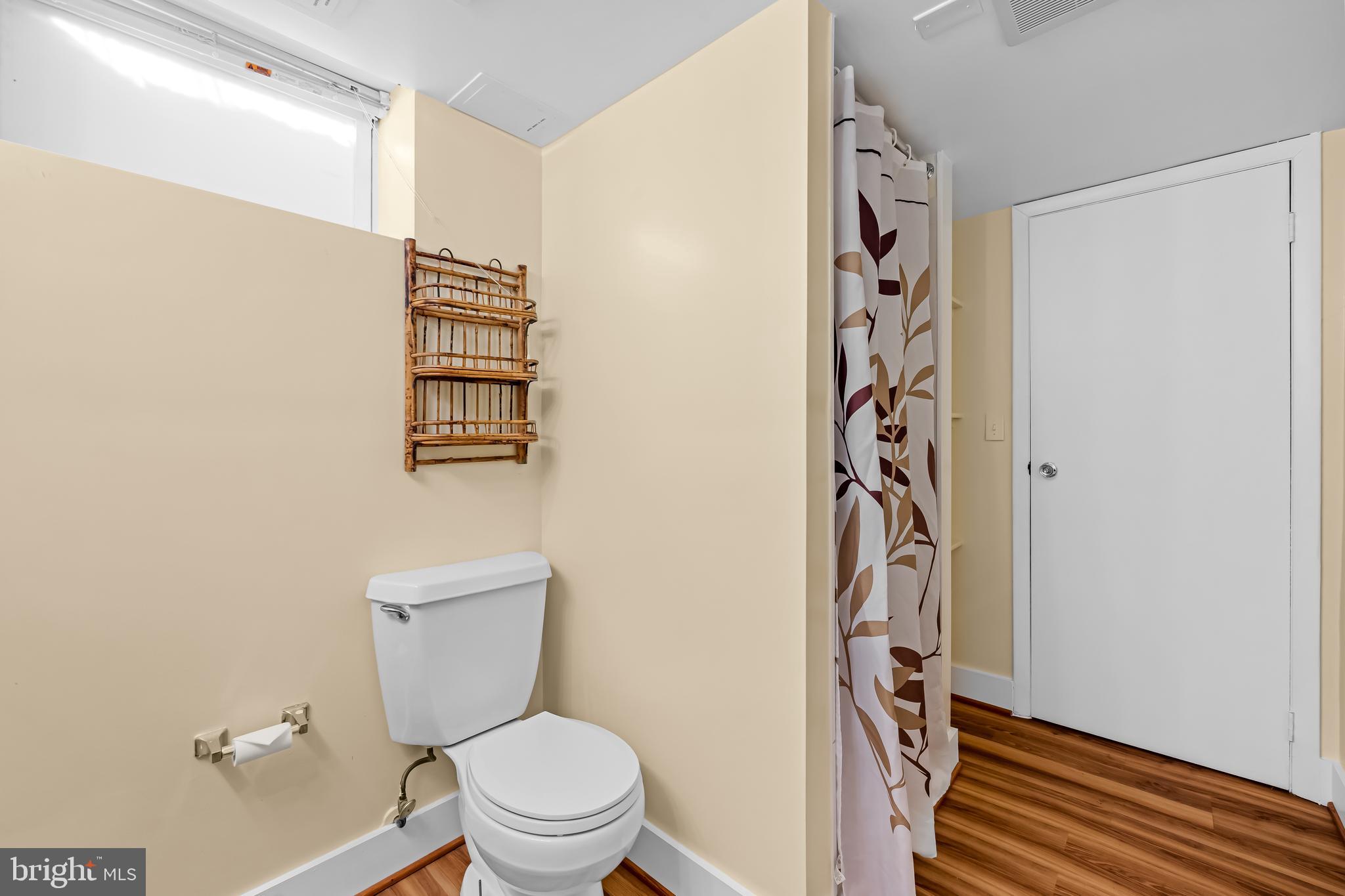 3407 Birch Hollow Road Baltimore, MD 21208 - Photo 44 of 47 a white toilet sitting next to a shower curtain
