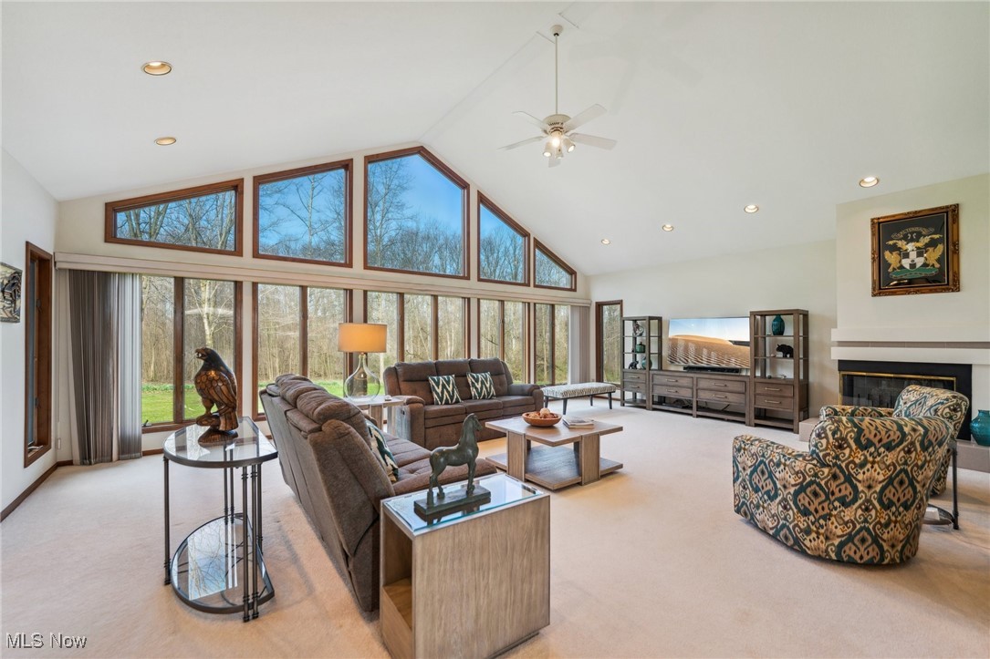 43301 Parsons Road Oberlin, OH 44074 - Photo 5 of 47 Living room with light carpet, plenty of natural light, high vaulted ceiling, and a ceiling fan