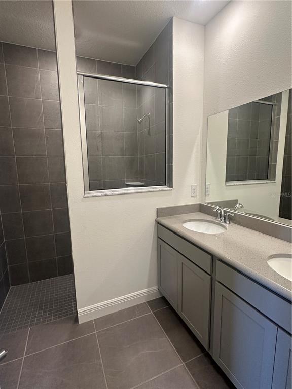 10776 Southwest 49th Ave Road Ocala, FL 34476 - Photo 4 of 9 a bathroom with a double vanity sink and a mirror