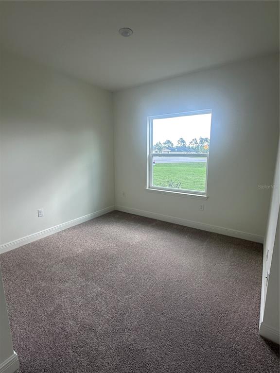 10776 Southwest 49th Ave Road Ocala, FL 34476 - Photo 5 of 9 an empty room with a window
