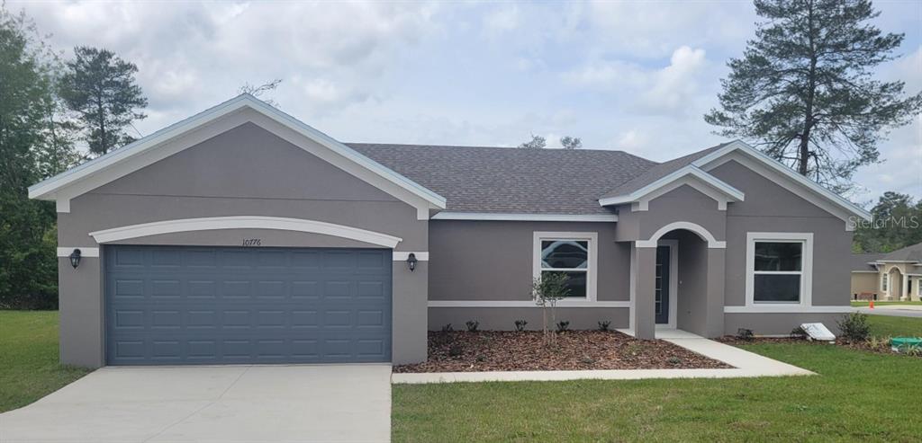 10776 Southwest 49th Ave Road Ocala, FL 34476 - Photo 9 of 9 a front view of a house with a yard