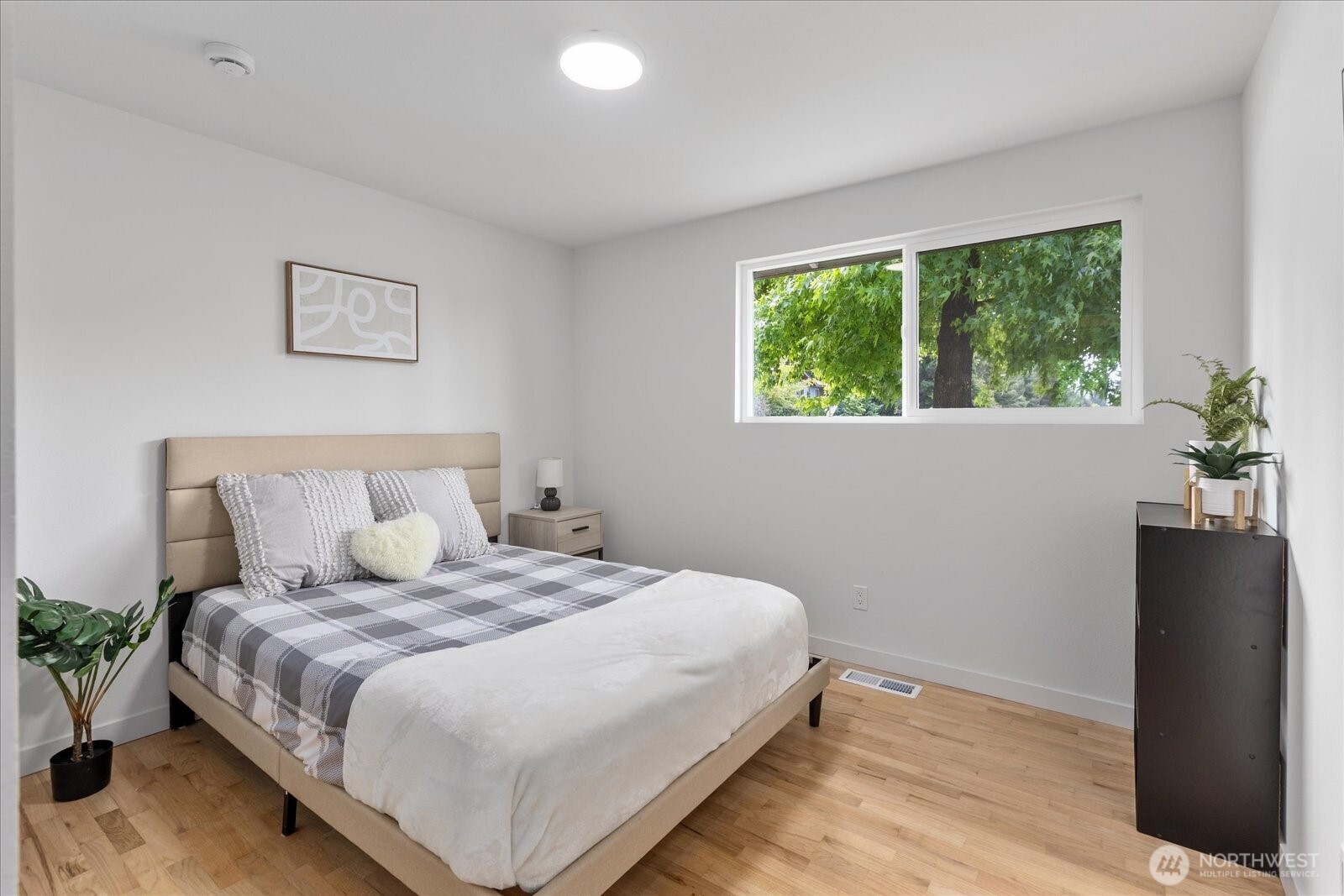 10646 Southeast 236th Street Kent, WA 98031 - Photo 13 of 20 a bedroom with a large bed and a potted plant