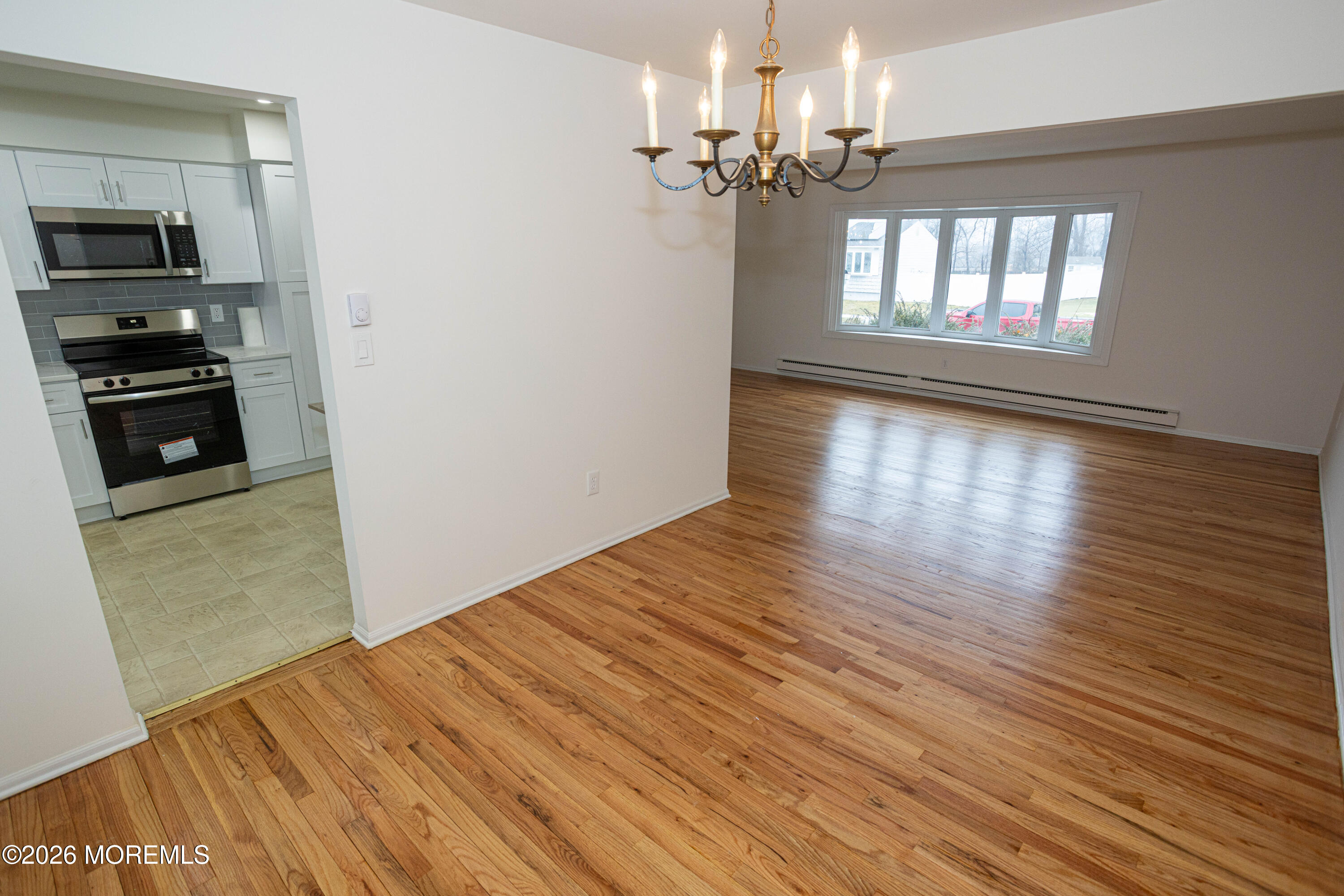21 Sherwood Road Parlin, NJ 08859 - Photo 13 of 41 an empty room with wooden floor chandelier and windows