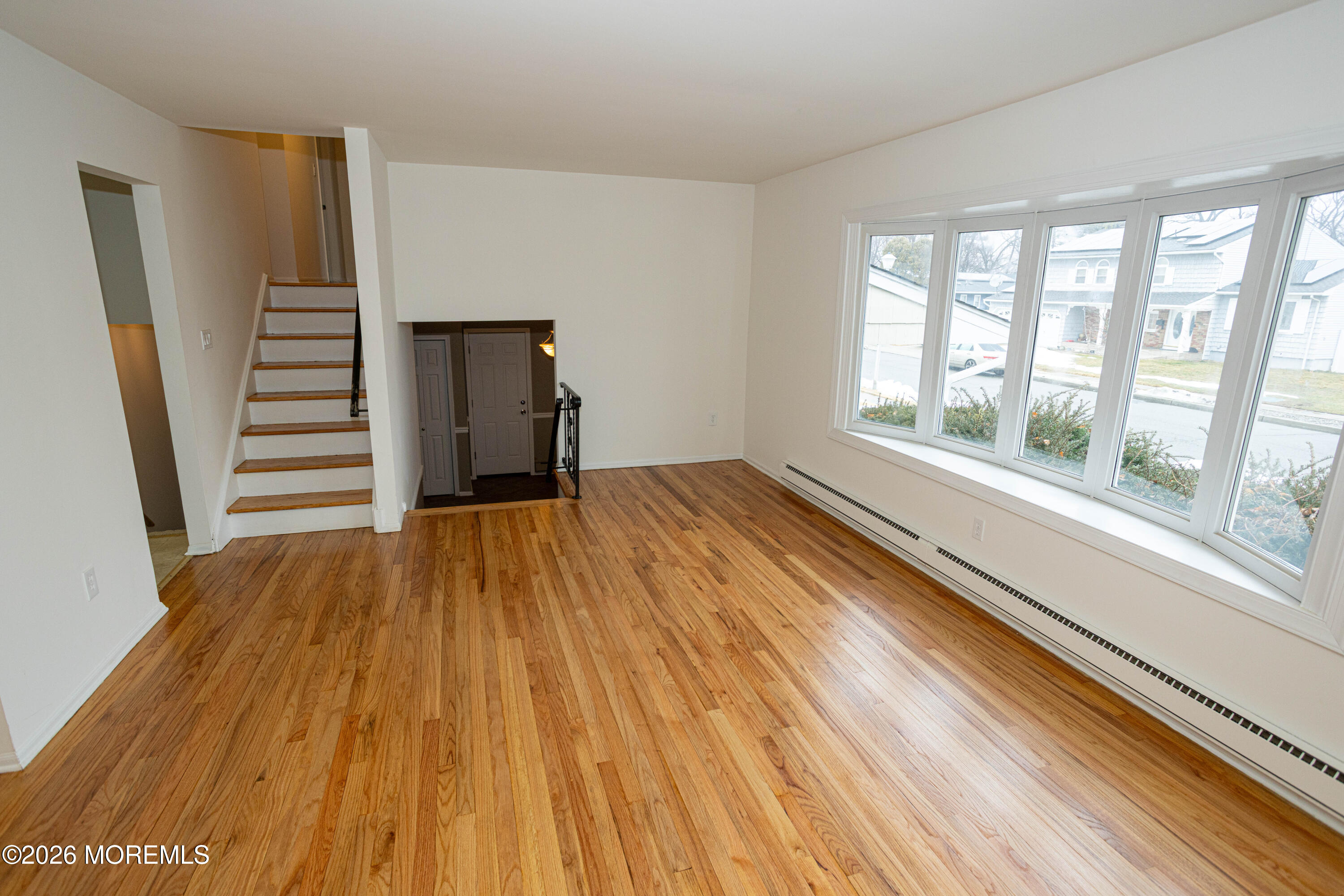 21 Sherwood Road Parlin, NJ 08859 - Photo 7 of 41 a view of an empty room with wooden floor and a window