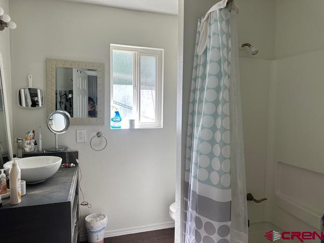 633 Alameda Cortez, CO 81321 - Photo 12 of 23 a bathroom with a granite countertop sink toilet a mirror and shower