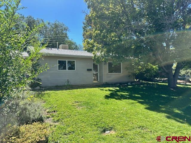633 Alameda Cortez, CO 81321 - Photo 3 of 23 a backyard of a house with plants and large tree