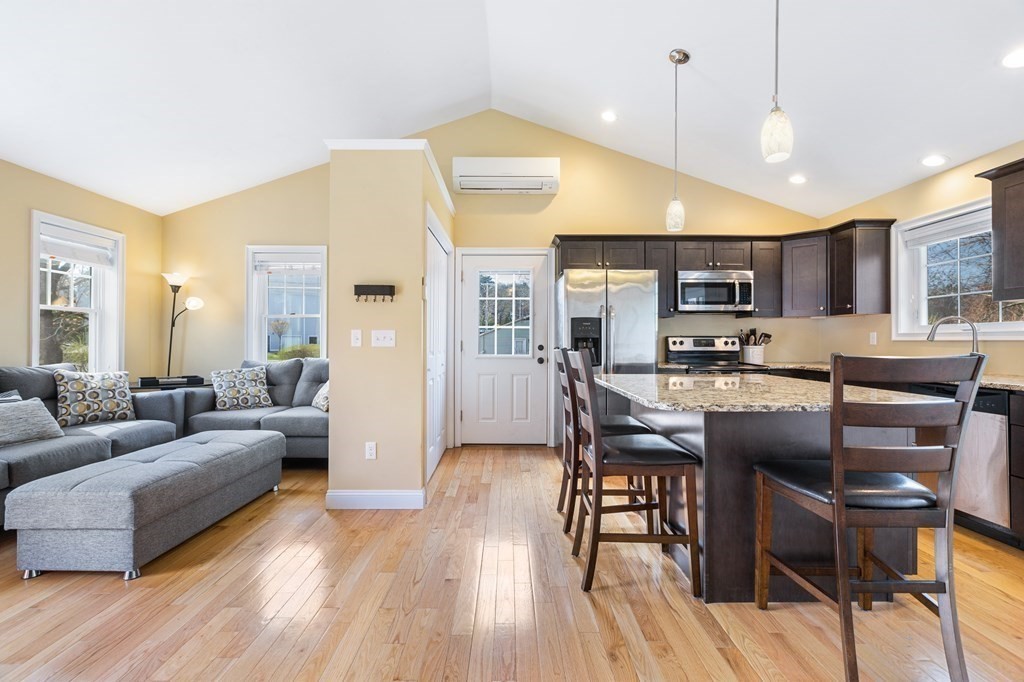 5 Powerstation Road Charlton, MA 01507 - Photo 6 of 21 a living room with stainless steel appliances kitchen island granite countertop furniture and a wooden floor