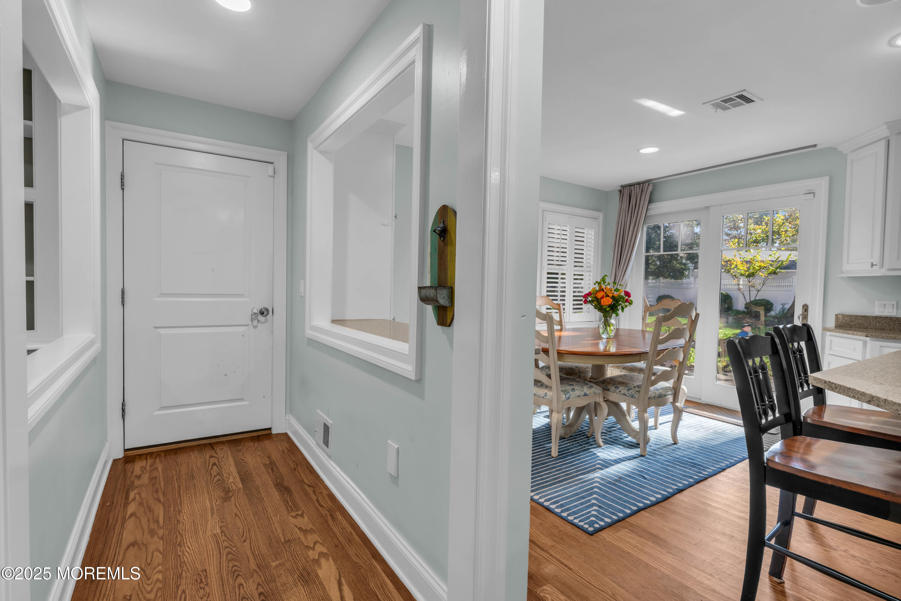 a view of a hallway with workspace and dining room view