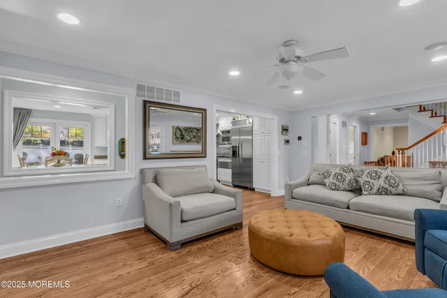 a kitchen with stainless steel appliances granite countertop a stove a refrigerator a kitchen island a table and chairs