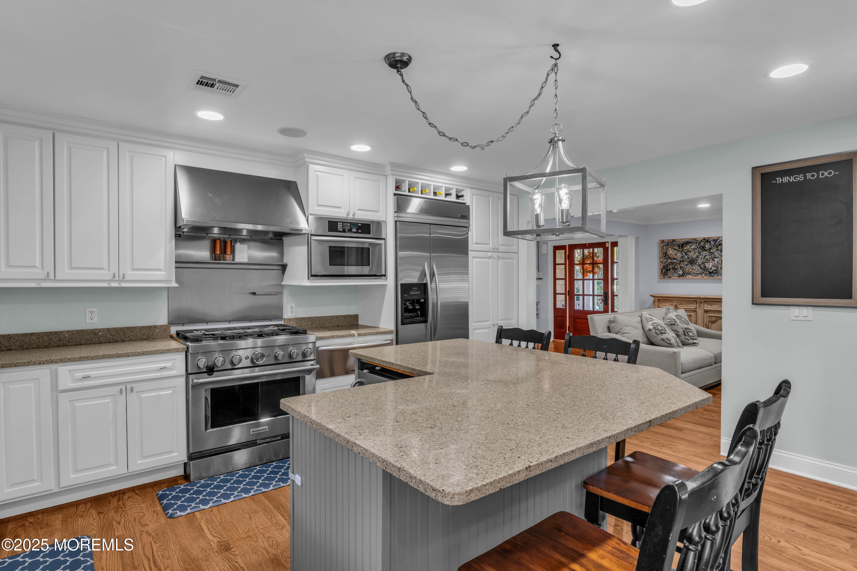 1004 Cedar Lane Brielle, NJ 08730 - Photo 16 of 62 a kitchen with kitchen island a stove a table and chairs in it