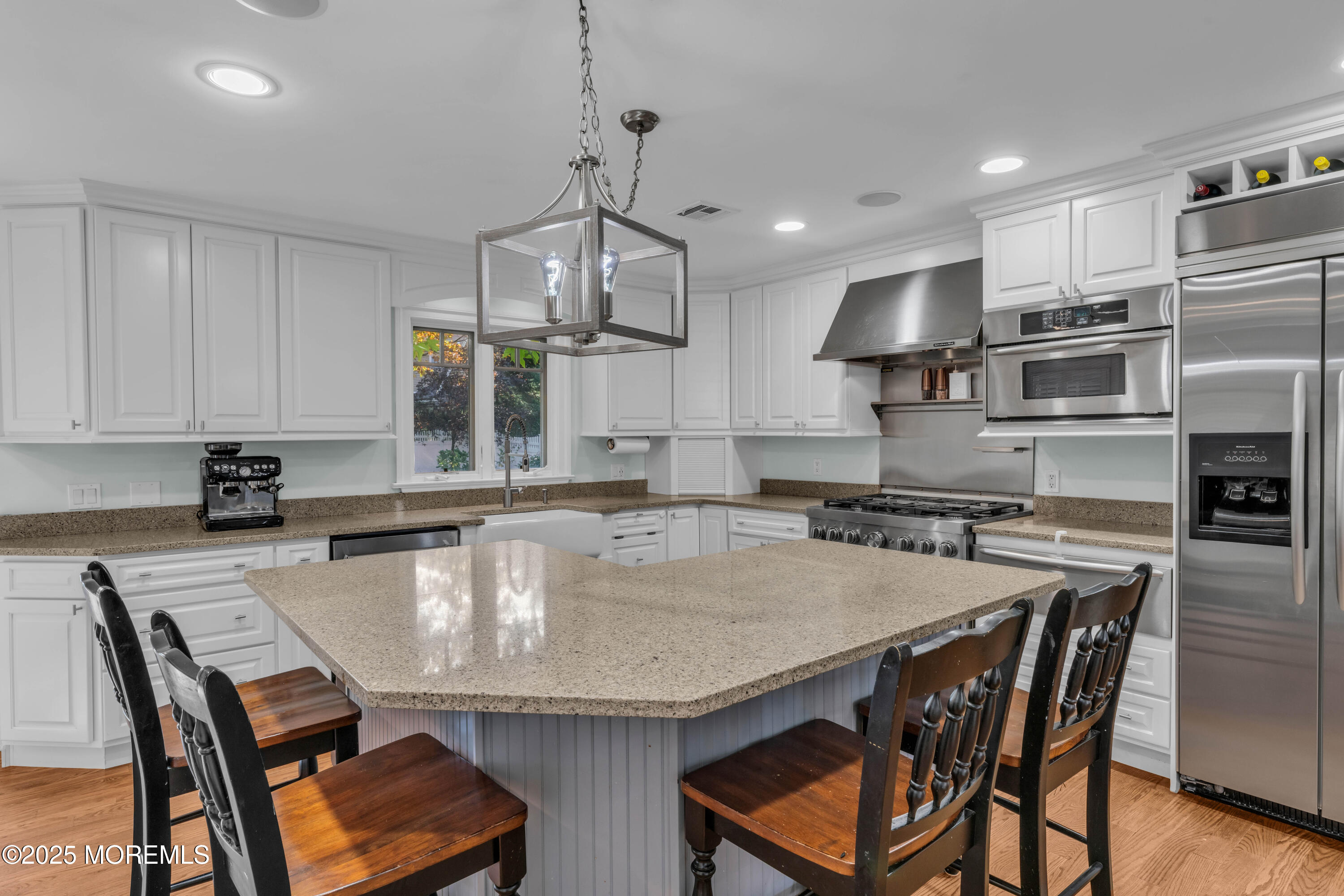 1004 Cedar Lane Brielle, NJ 08730 - Photo 17 of 62 a kitchen with stainless steel appliances granite countertop a stove a refrigerator a kitchen island a table and chairs
