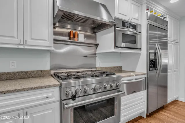 a spacious bedroom with a large bed and a flat screen tv