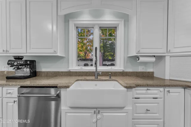 a bathroom with a granite countertop sink toilet a mirror and a shower