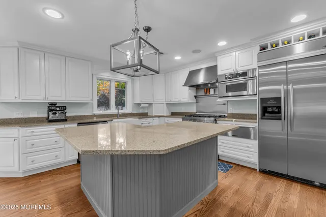 a kitchen with a stove and a white cabinets
