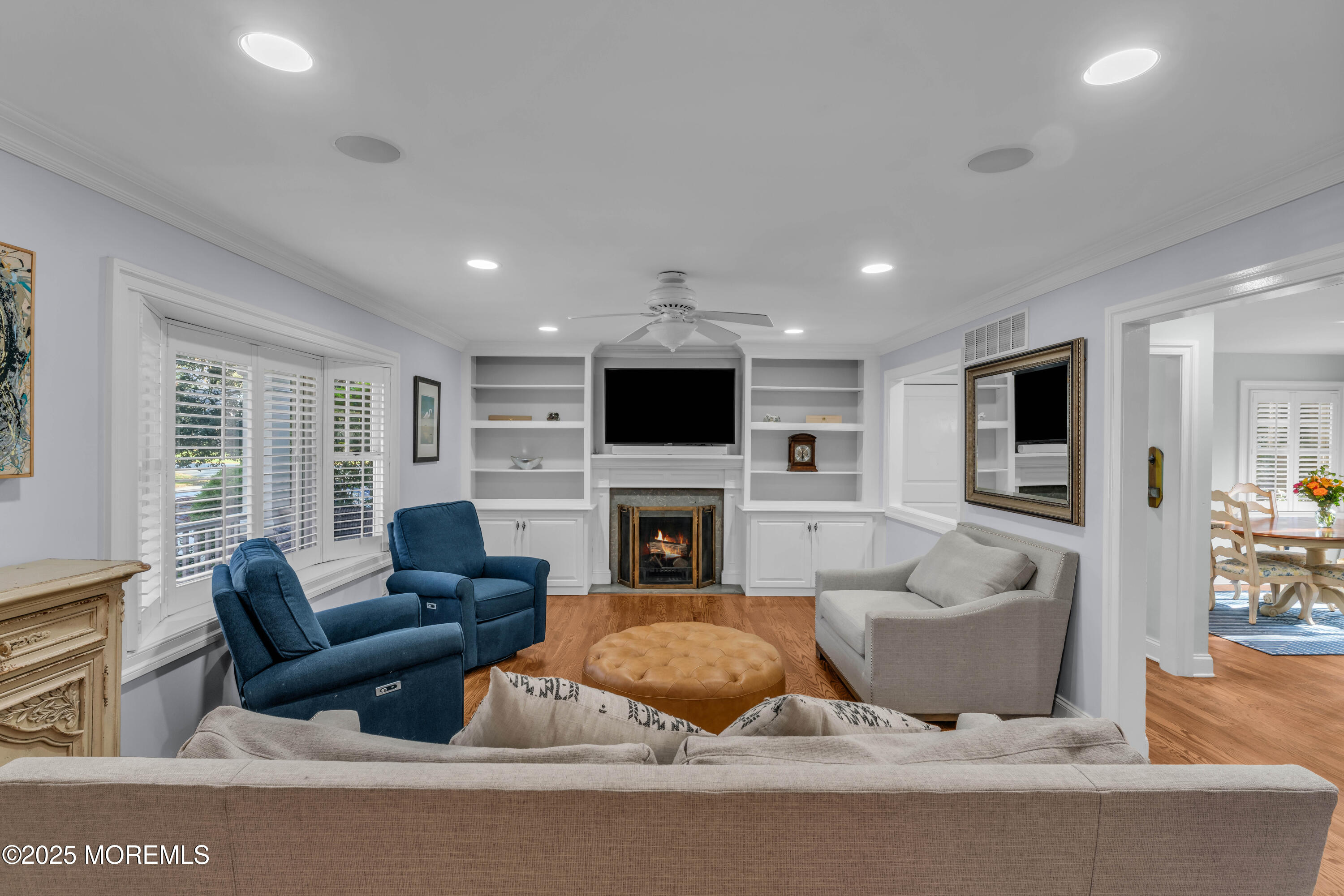 1004 Cedar Lane Brielle, NJ 08730 - Photo 21 of 62 a living room with furniture a fireplace and a flat screen tv
