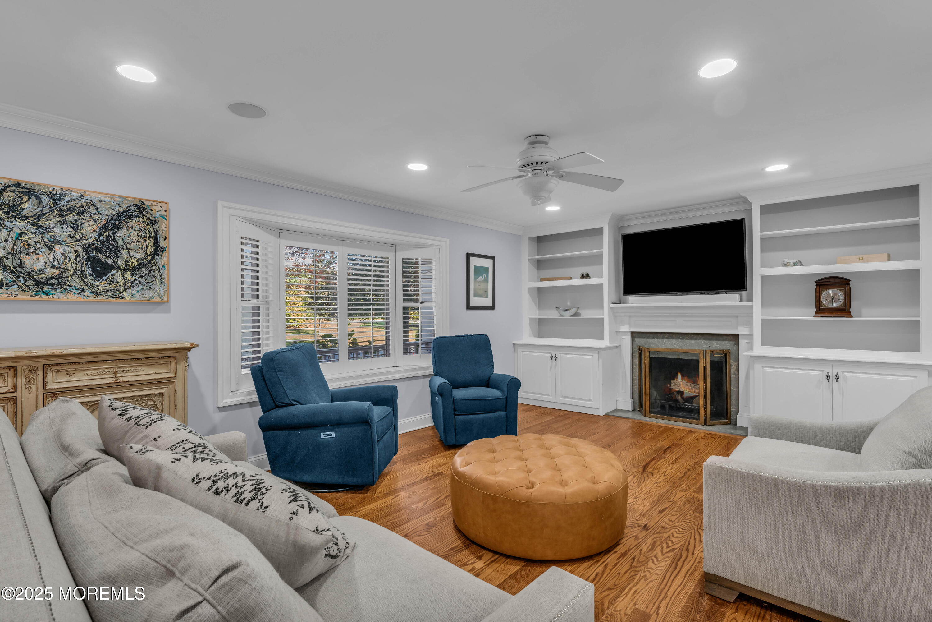 1004 Cedar Lane Brielle, NJ 08730 - Photo 22 of 62 a living room with furniture a fireplace and a flat screen tv