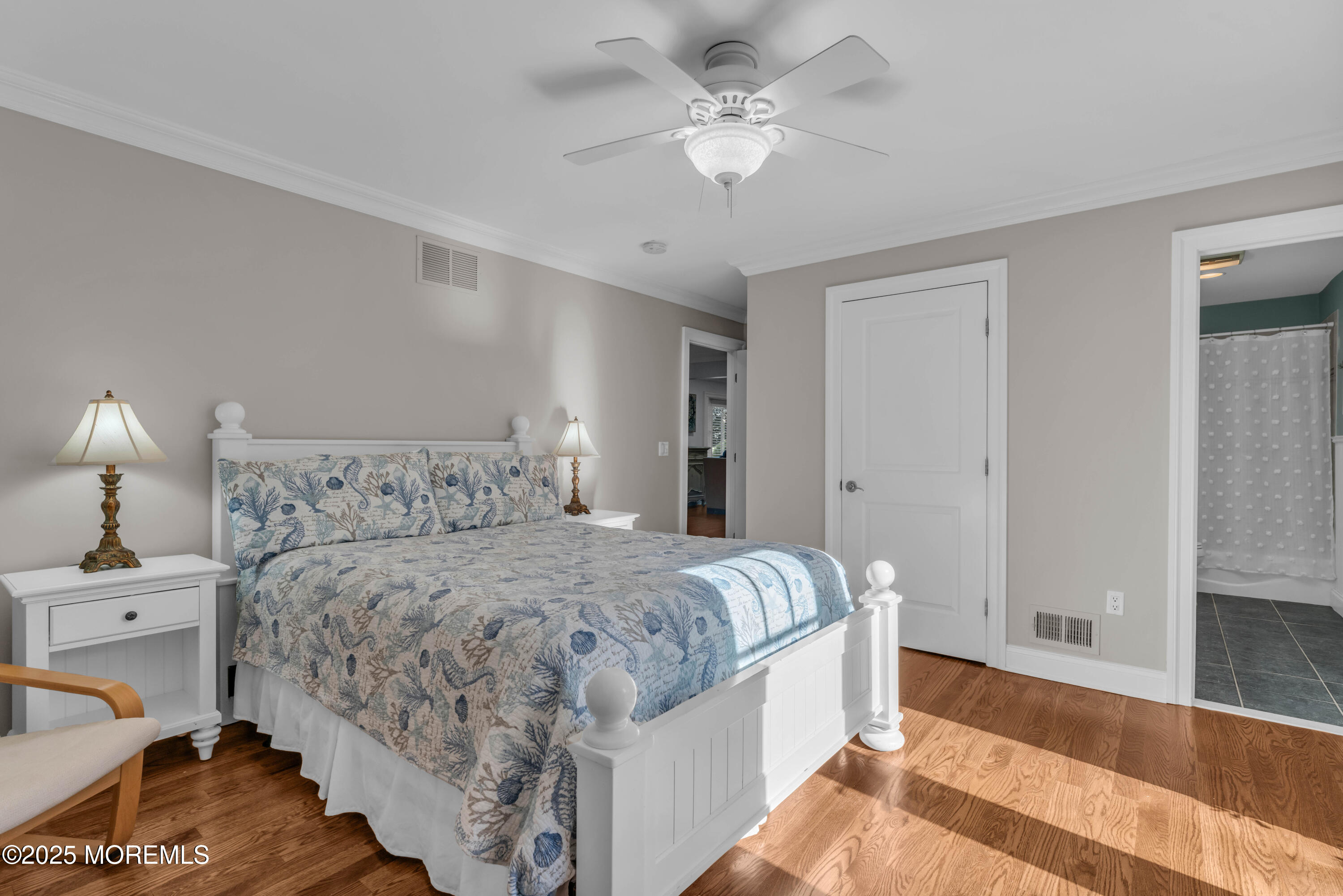 1004 Cedar Lane Brielle, NJ 08730 - Photo 23 of 62 a bedroom with bed and a chandelier