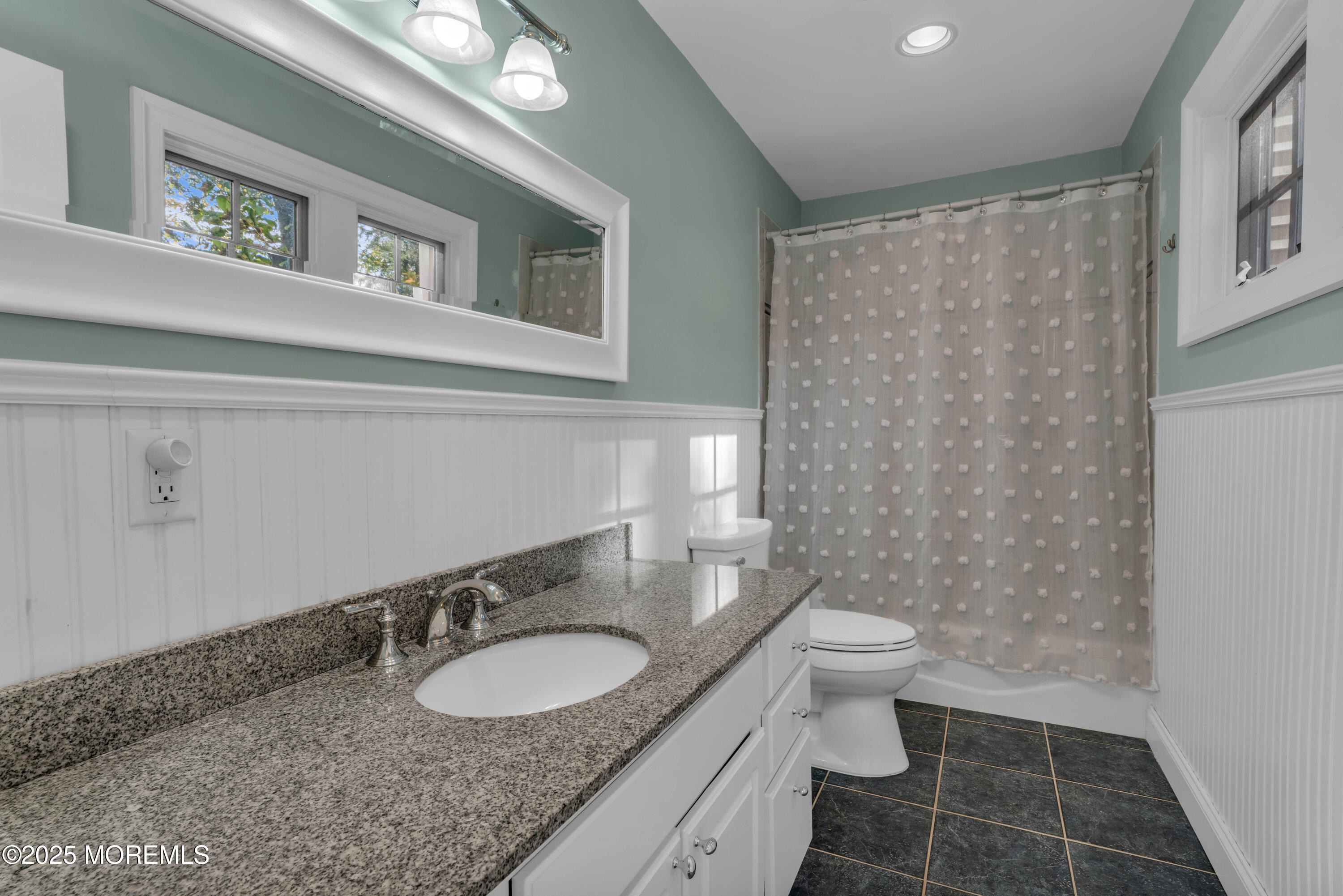 1004 Cedar Lane Brielle, NJ 08730 - Photo 25 of 62 a bathroom with a granite countertop sink toilet a mirror and a shower