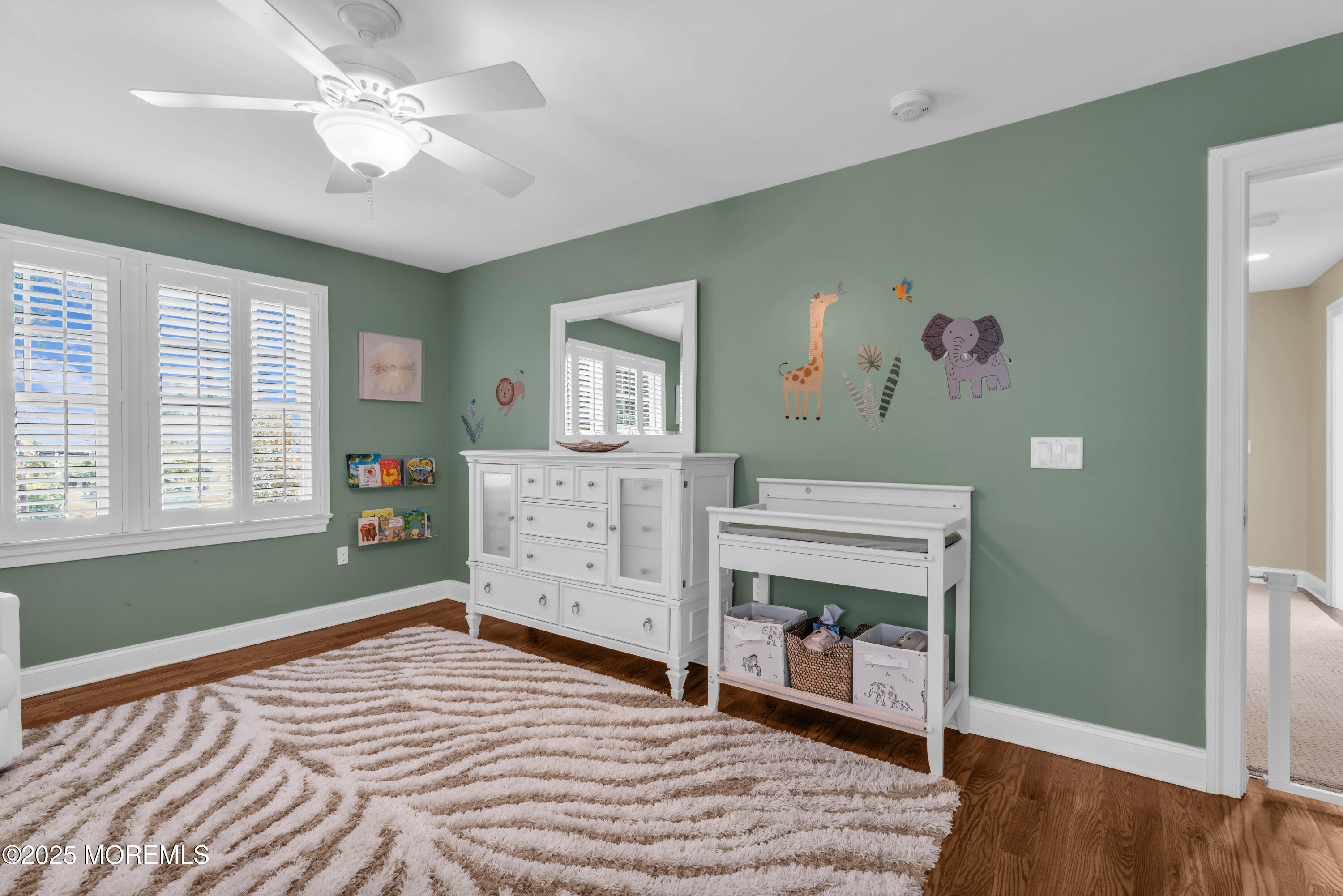 1004 Cedar Lane Brielle, NJ 08730 - Photo 40 of 62 a bedroom with a bed and a chandelier