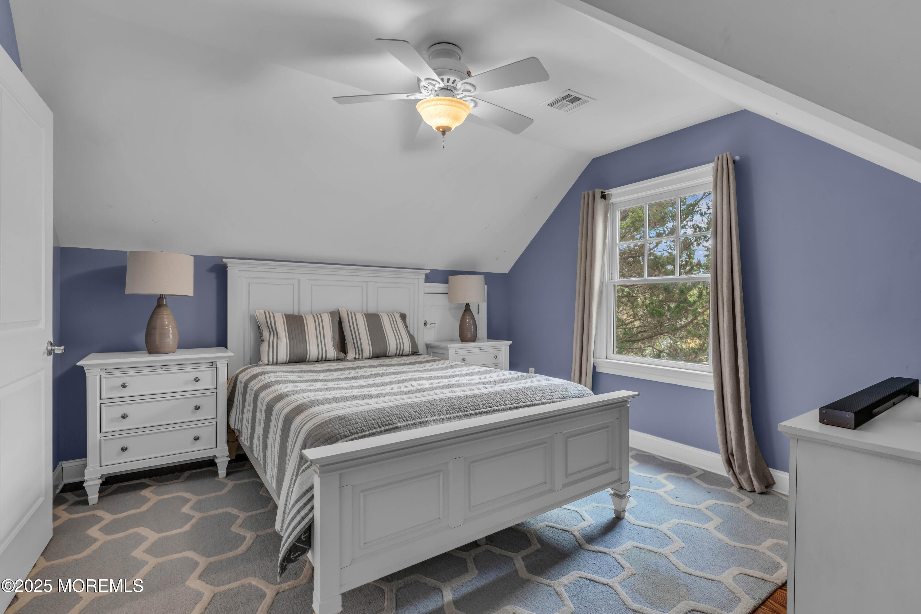 1004 Cedar Lane Brielle, NJ 08730 - Photo 44 of 62 a bedroom with a bed and a chandelier