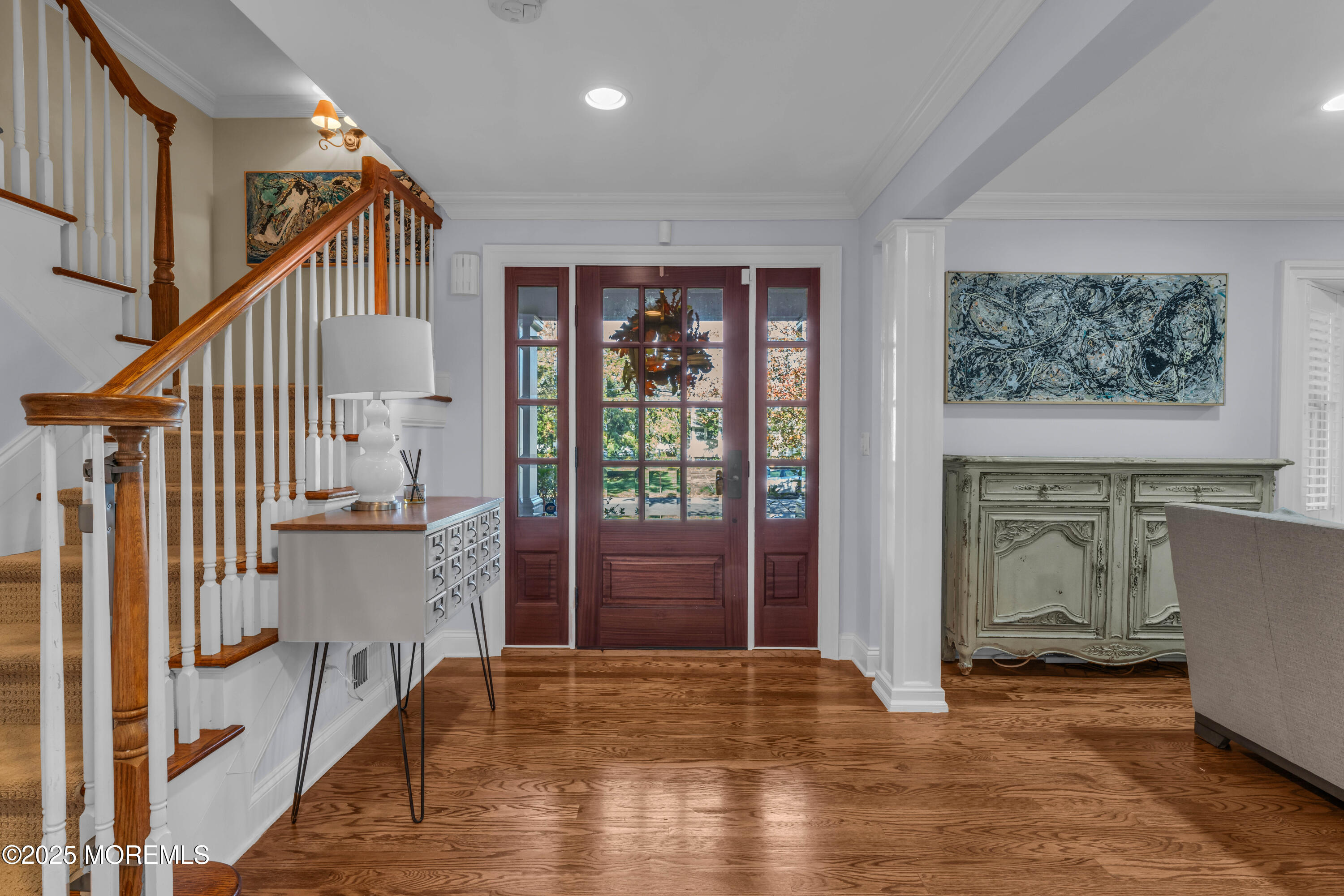 1004 Cedar Lane Brielle, NJ 08730 - Photo 7 of 62 a view of hallway with stairs and wooden floor