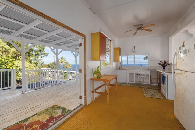 a living room with lots of furniture and a large window