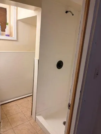 a bathroom with a glass shower door