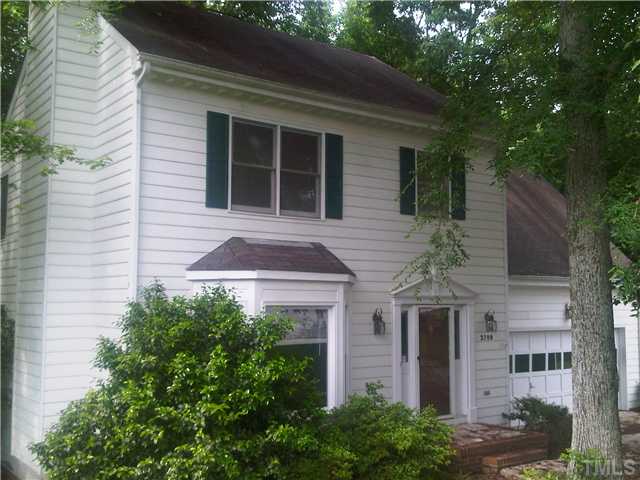 2700 Westhampton Place Raleigh, NC 27604 - Photo 1 of 3 a front view of a house with a yard and potted plants