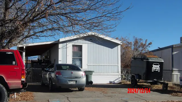 a front view of a house with a tree