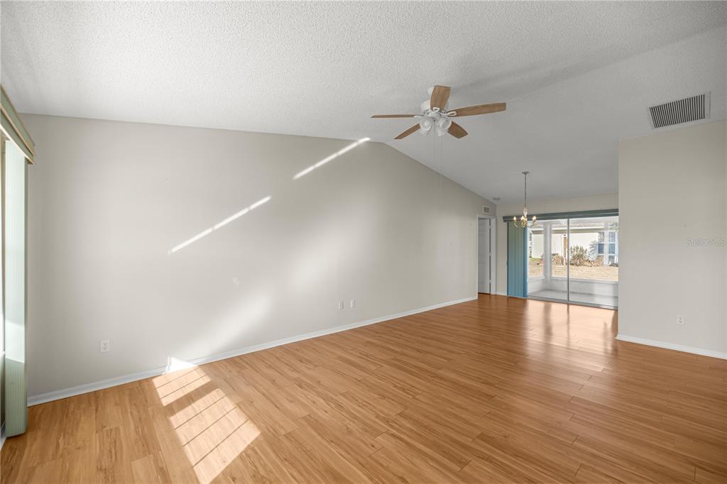 8478 Southwest 61st Terrace Road Ocala, FL 34476 - Photo 12 of 39 a view of empty room with wooden floor and fan