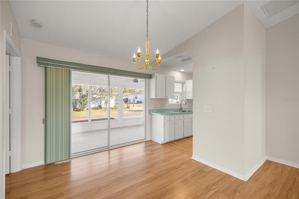 8478 Southwest 61st Terrace Road Ocala, FL 34476 - Photo 13 of 39 a view of a kitchen and an empty room