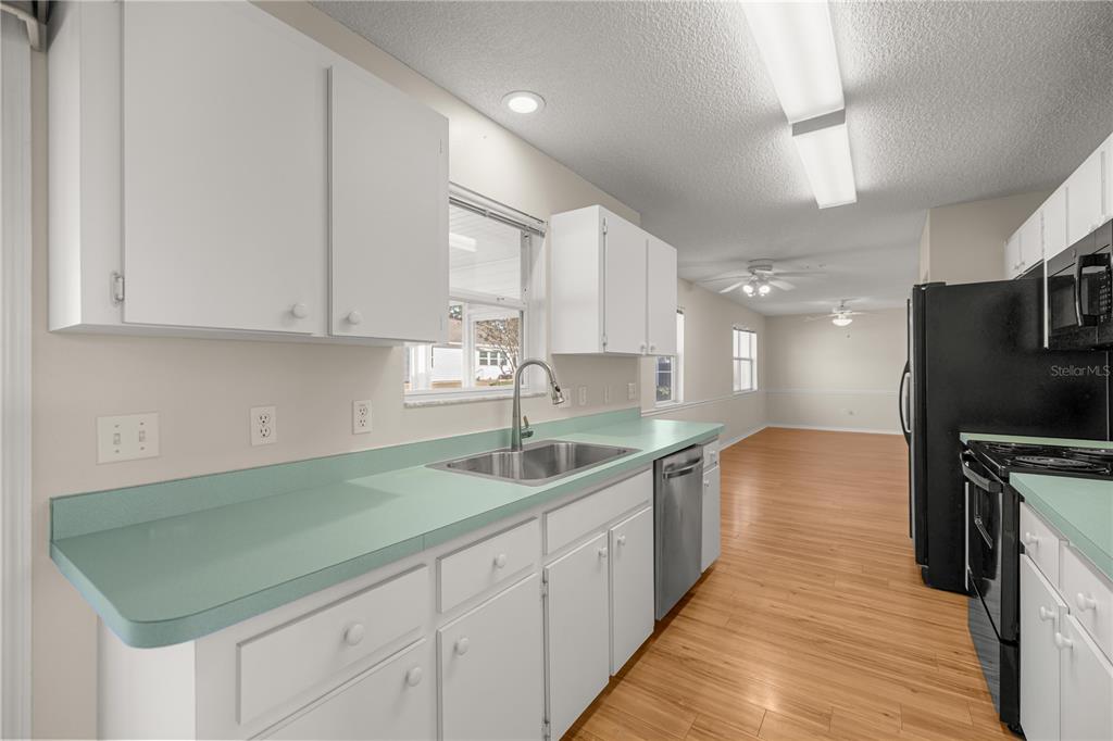 8478 Southwest 61st Terrace Road Ocala, FL 34476 - Photo 17 of 39 a kitchen with sink cabinets and stove