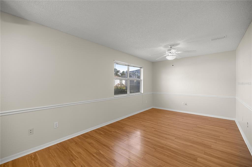 8478 Southwest 61st Terrace Road Ocala, FL 34476 - Photo 20 of 39 a view of an empty room with wooden floor and a window