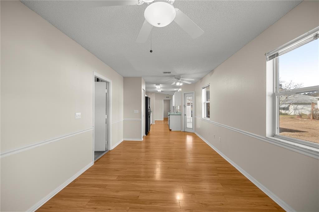 8478 Southwest 61st Terrace Road Ocala, FL 34476 - Photo 21 of 39 a view of an empty room with wooden floor and a window