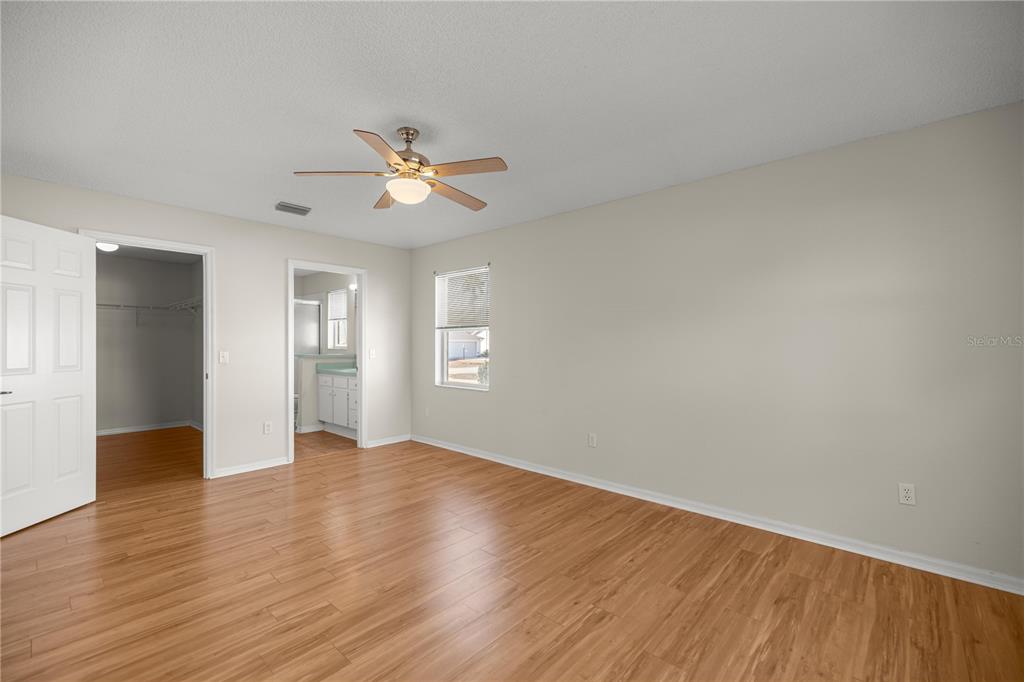 8478 Southwest 61st Terrace Road Ocala, FL 34476 - Photo 24 of 39 a view of empty room with wooden floor and fan