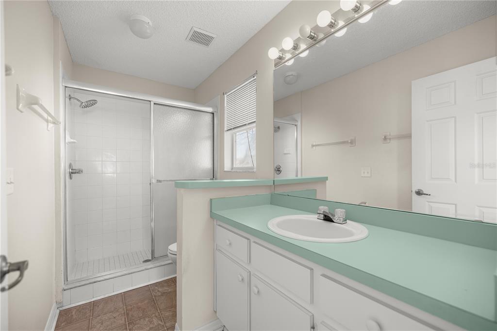 8478 Southwest 61st Terrace Road Ocala, FL 34476 - Photo 26 of 39 a bathroom with a sink a shower and a mirror