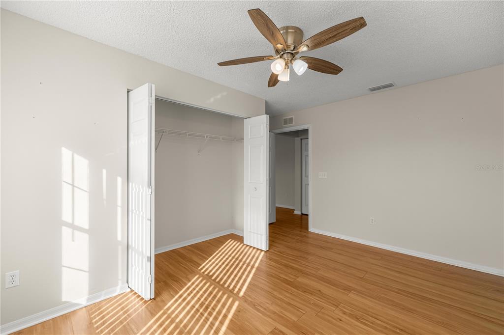 8478 Southwest 61st Terrace Road Ocala, FL 34476 - Photo 29 of 39 an empty room with wooden floor and windows