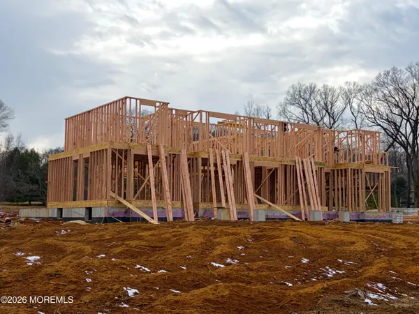 a view of a blue house with wooden fence