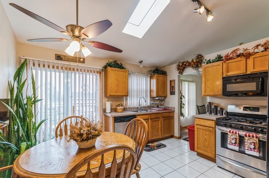 509 Farmview Road University Park, IL 60484 - Photo 5 of 19 a kitchen with stainless steel appliances a table and chairs in it