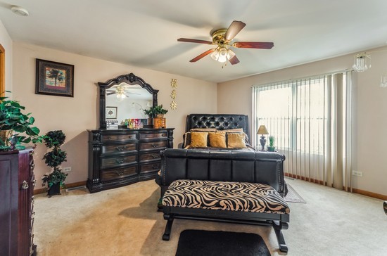 509 Farmview Road University Park, IL 60484 - Photo 7 of 19 a bedroom with a bed and a chandelier