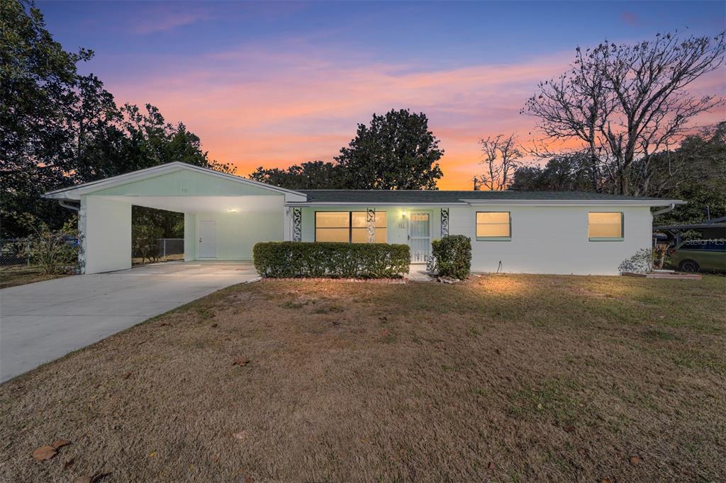 911 Northeast 45th Street Ocala, FL 34479 - Photo 1 of 1 a front view of a house with garden