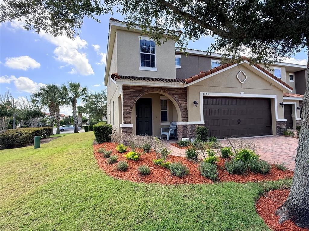 2084 Water Tupelo Way Ocoee, FL 34761 - Photo 1 of 34 a front view of a house with a porch and a yard