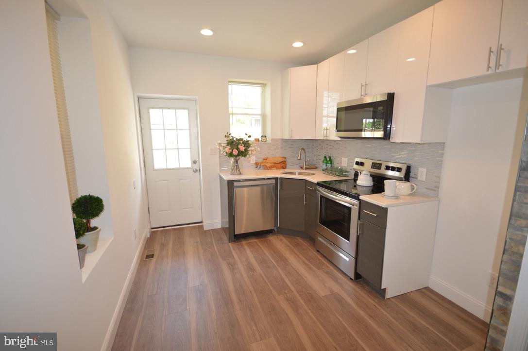 1827 Dudley Street Philadelphia, PA 19145 - Photo 2 of 15 a kitchen with sink a microwave and cabinets
