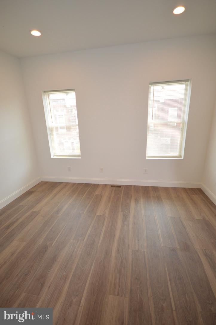 1827 Dudley Street Philadelphia, PA 19145 - Photo 12 of 15 an empty room with wooden floor and windows