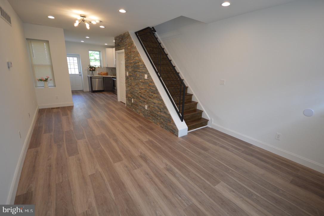 1827 Dudley Street Philadelphia, PA 19145 - Photo 4 of 15 wooden floor in an empty room with a kitchen