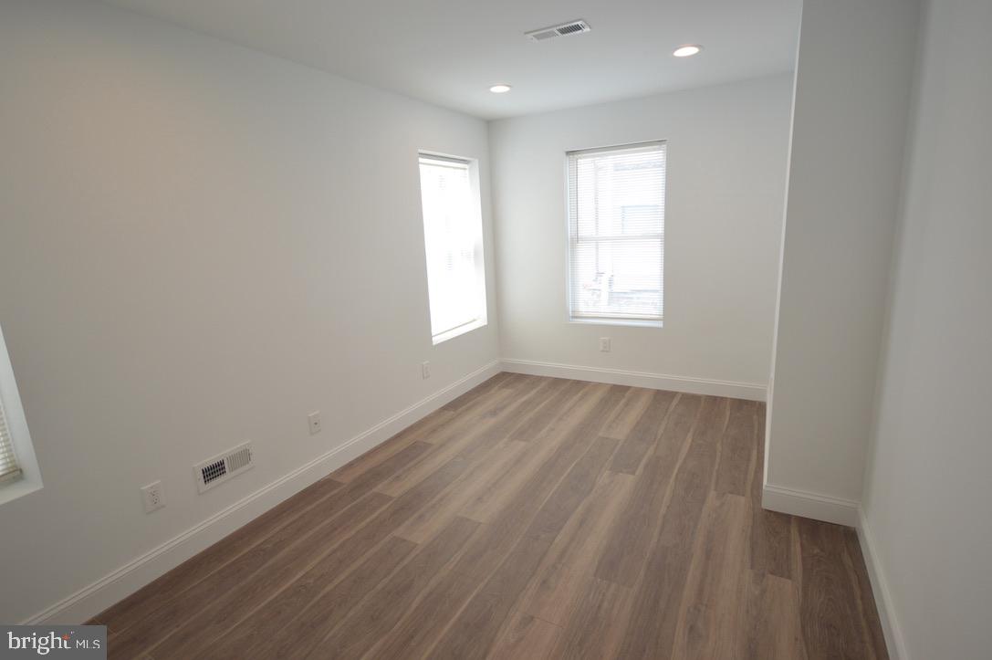 1827 Dudley Street Philadelphia, PA 19145 - Photo 7 of 15 a view of an empty room with wooden floor and window