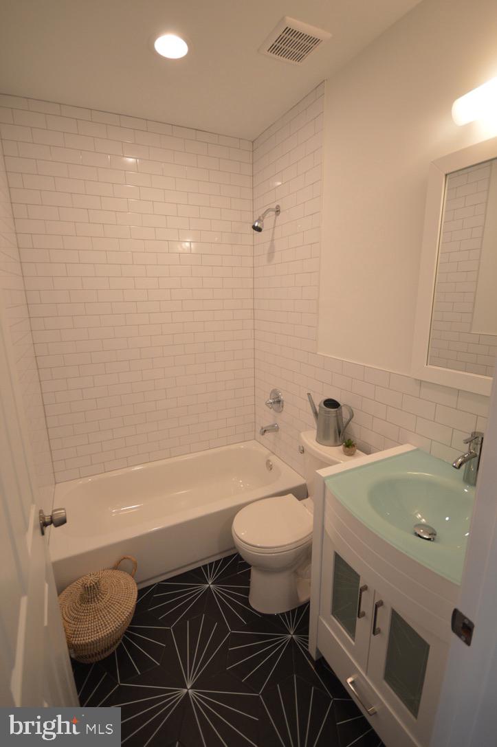 1827 Dudley Street Philadelphia, PA 19145 - Photo 9 of 15 a bathroom with a sink toilet a shower and bathtub